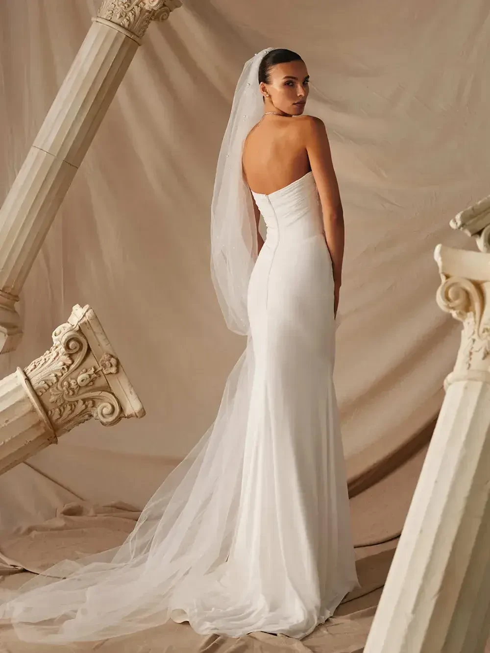 model is wearing an off the shoulder fit and flare bridal gown